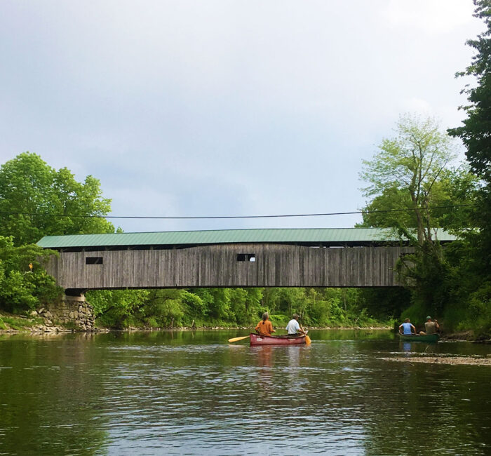 Poland Covered Bridge with paddlers beneath it.