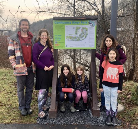 Kids and families with sign at Confluence River Park in Montpelier, VT
