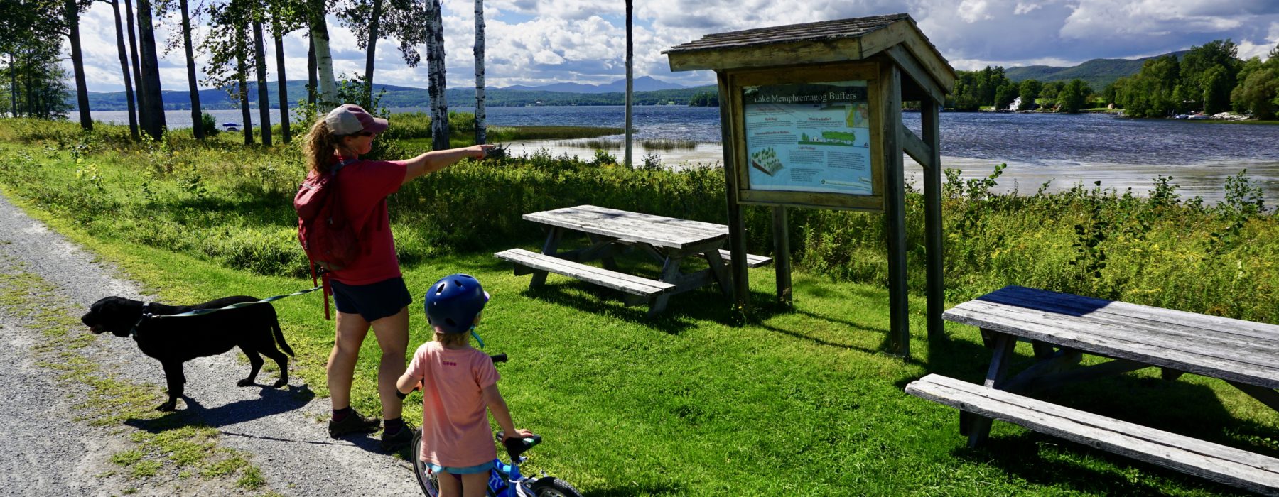 Mom, kid, and dog ready to bike along Lake Memphremagog in Vermont.