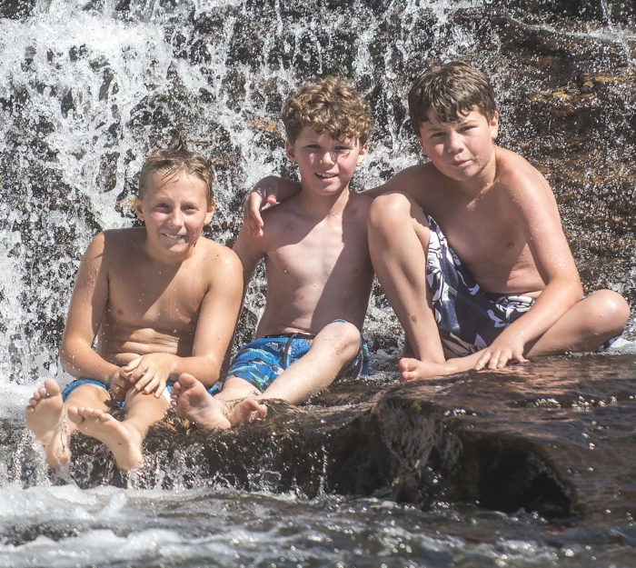 Three kids at a Vermont swimming hole.