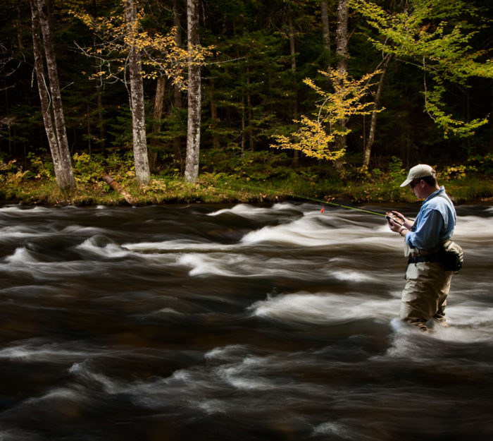 Angler fishes a Vermont river.