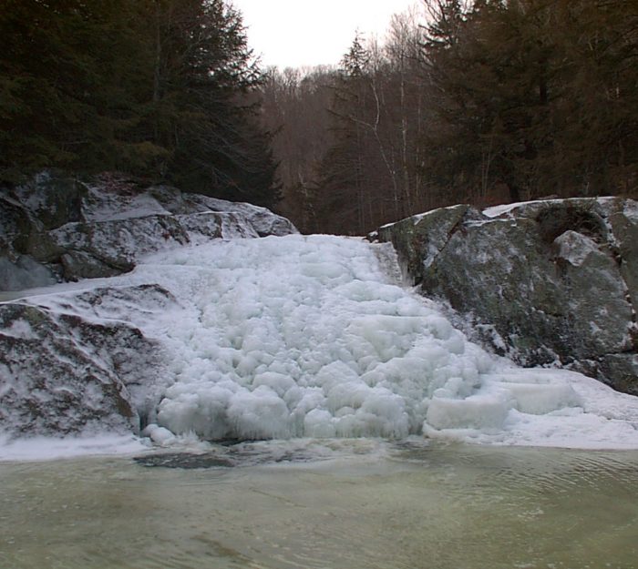 Buttermilk Falls frozen in winter in Ludlow, Vermont.