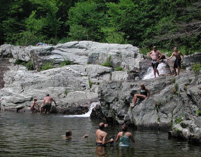 Swimmers enjoying Buttermilk Falls in Ludlow, Vermont.