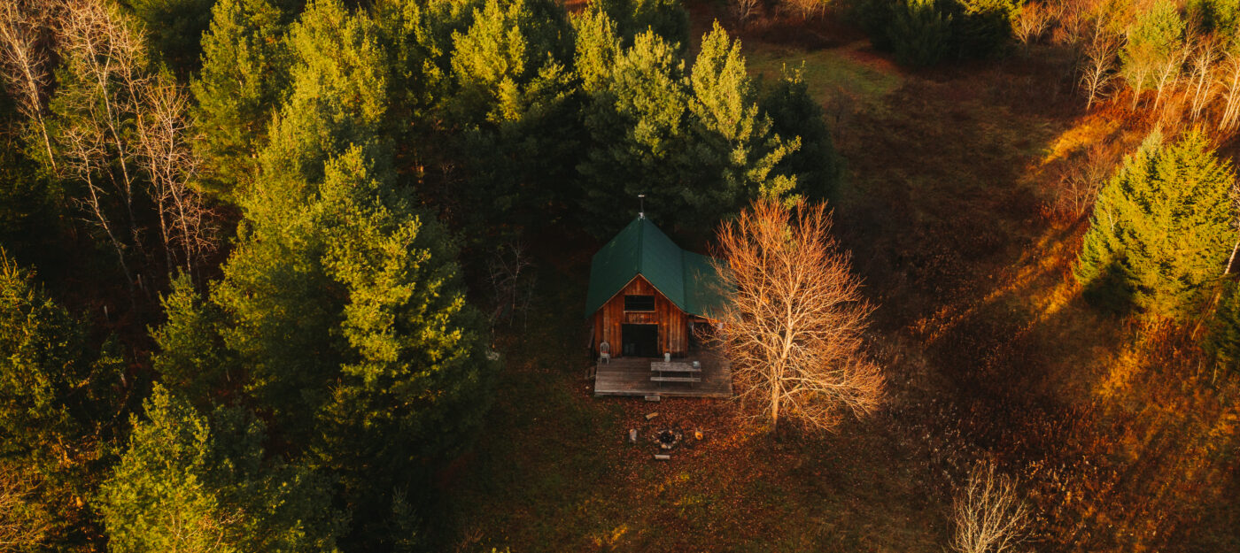 Nulhegan Hut from above surrounded by fall foliage. 
