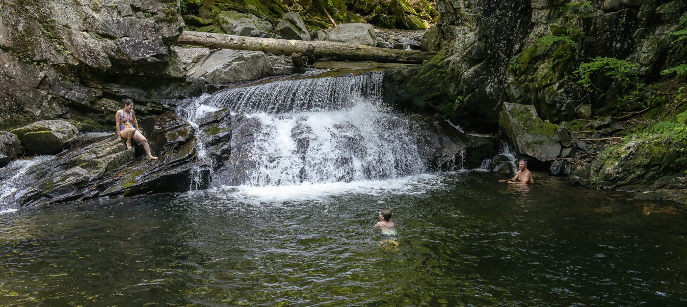 Family at a swimming hole in Vermont