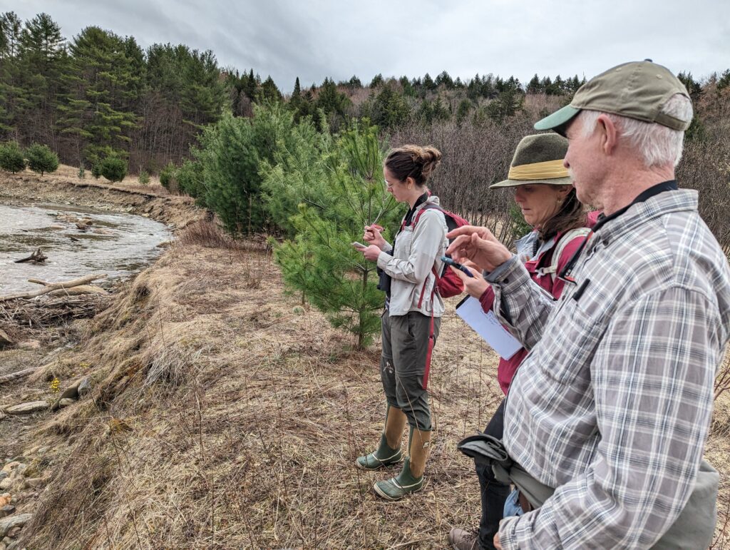 Mike Kline, Erin De Vries, and Hayley Kolding monitor the Selawsky River Corridor Easement along the Wild Branch river in Wolcott, VT.