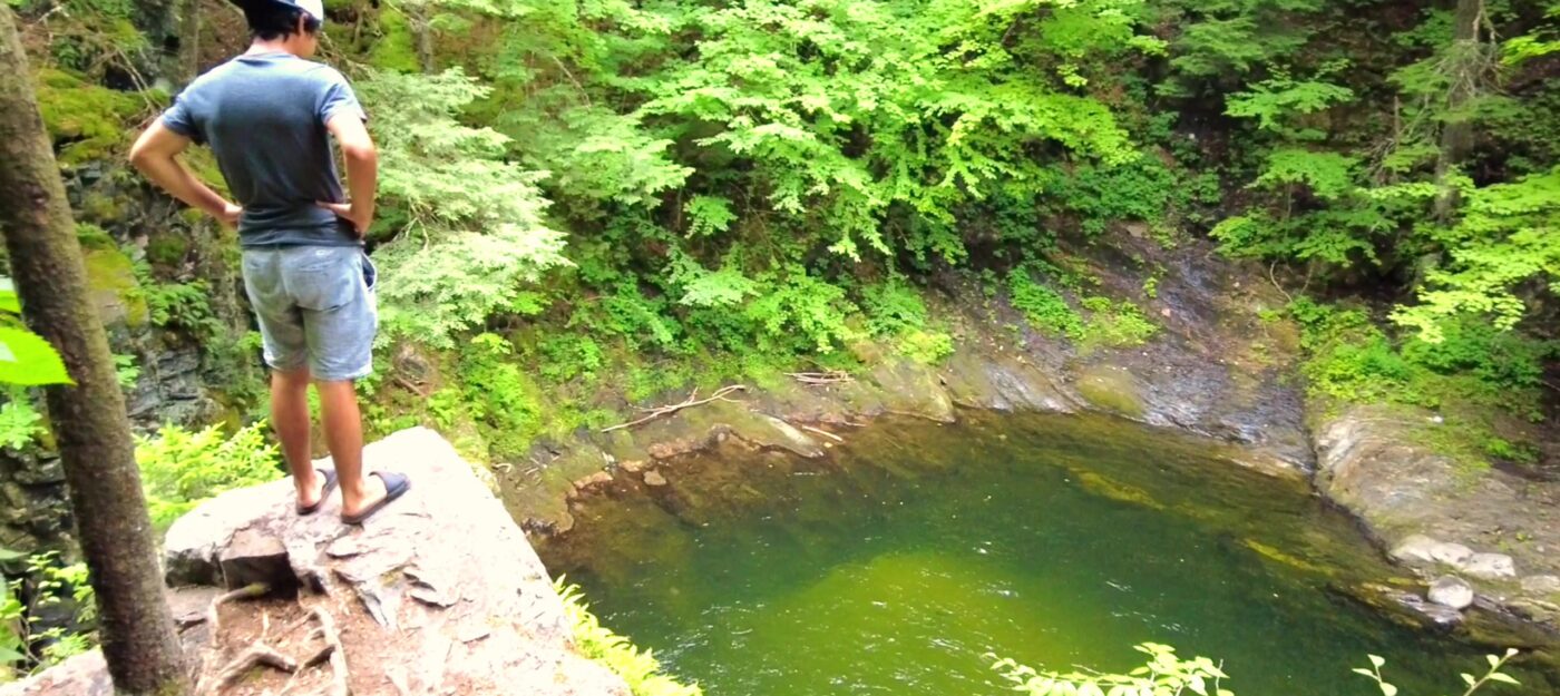 Swimming hole visitor stands above Terrill Gorge