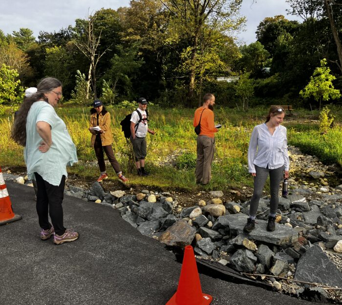 Group considers the damage to the road at Melrose Terrace following Vermont's July floods