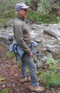 Brian stands alongside the river at Hancock Brook.