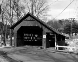 Black and white photo of the covered bridge showing the footbridge and driving sides.
