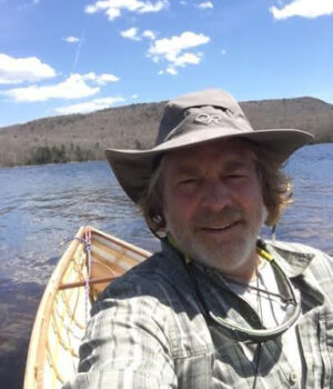 Derek sits in his canoe out on the water.