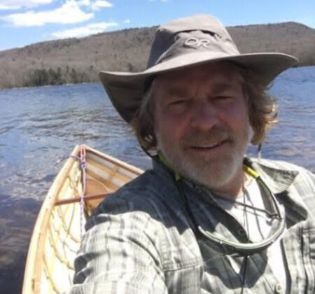 Derek sits in his canoe out on the water.